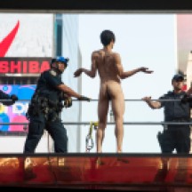 NYPD trying to remove naked man atop TKTS Booth in Times Square, just before jumping, missing NYPD airbag and injuring himself.