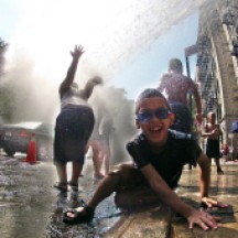 Children cooling off in spray of fire hydrant, Washington Heights, NYC
