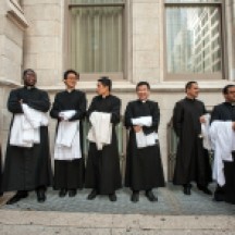 Scenes from the St. Patrick's Day Parade, Fifth Ave, NYC. Group of priests outside St. Patrick's cathedral after mass.