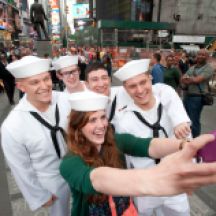 People doing selfies with sailors in Times Square during Fleet Week