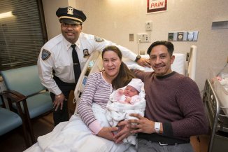 122618-CHRISTMAS-BABY-DM-10 Proud parents holding newborn baby in Bellevue Hospital after father, along with two NYPD officers, delivered baby at the Queens Midtown Tunnel plaza last night. Here: Lieutenant Harry Persad, Maria Albarracin 36, Ivan Albarracin 39, baby: Alie Aurora Albarracin. David McGlynn 12/26/18